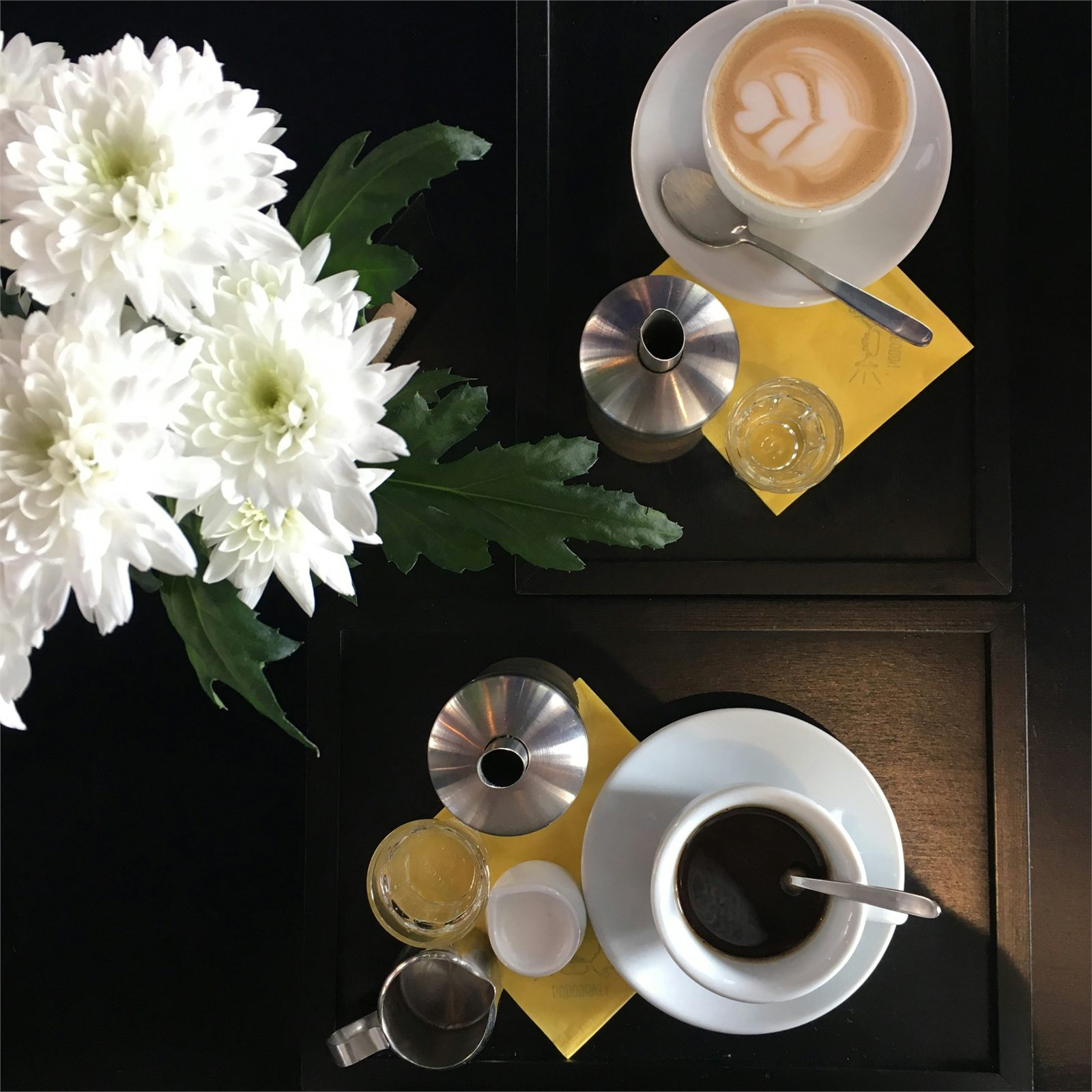 Fresh flowers beside coffee at Columbo Coffee