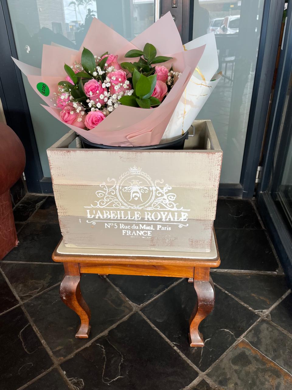 A bouquet ready for collection in a wooden florist crate